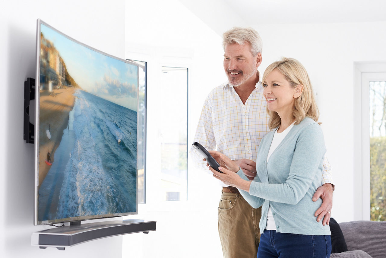 Seniors looking at TV with sound bar